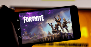 A smartphone with the Fortnite start screen.