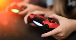 hands of children holding gaming consoles controller