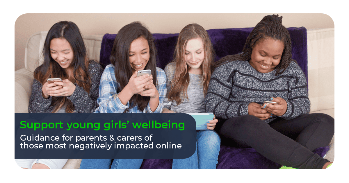 Four girls on a sofa with devices