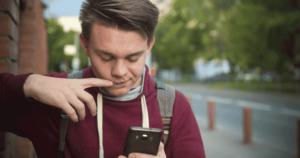 Child looking worried onsmartphone