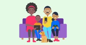 A family sitting together on a sofa, holding devices.