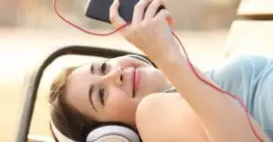 A child using her phone, looking happy