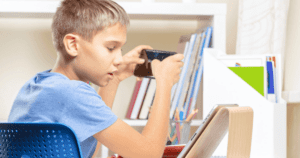 Child in bedroom playing on tablet