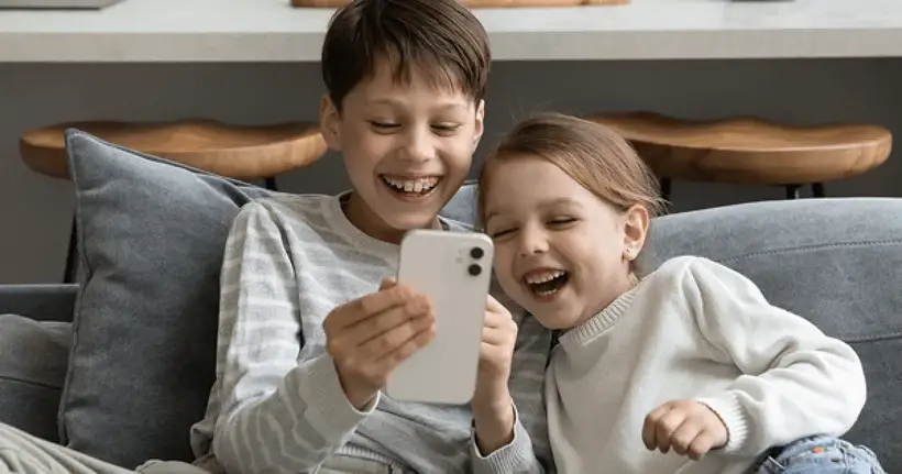 two kids playing on phone